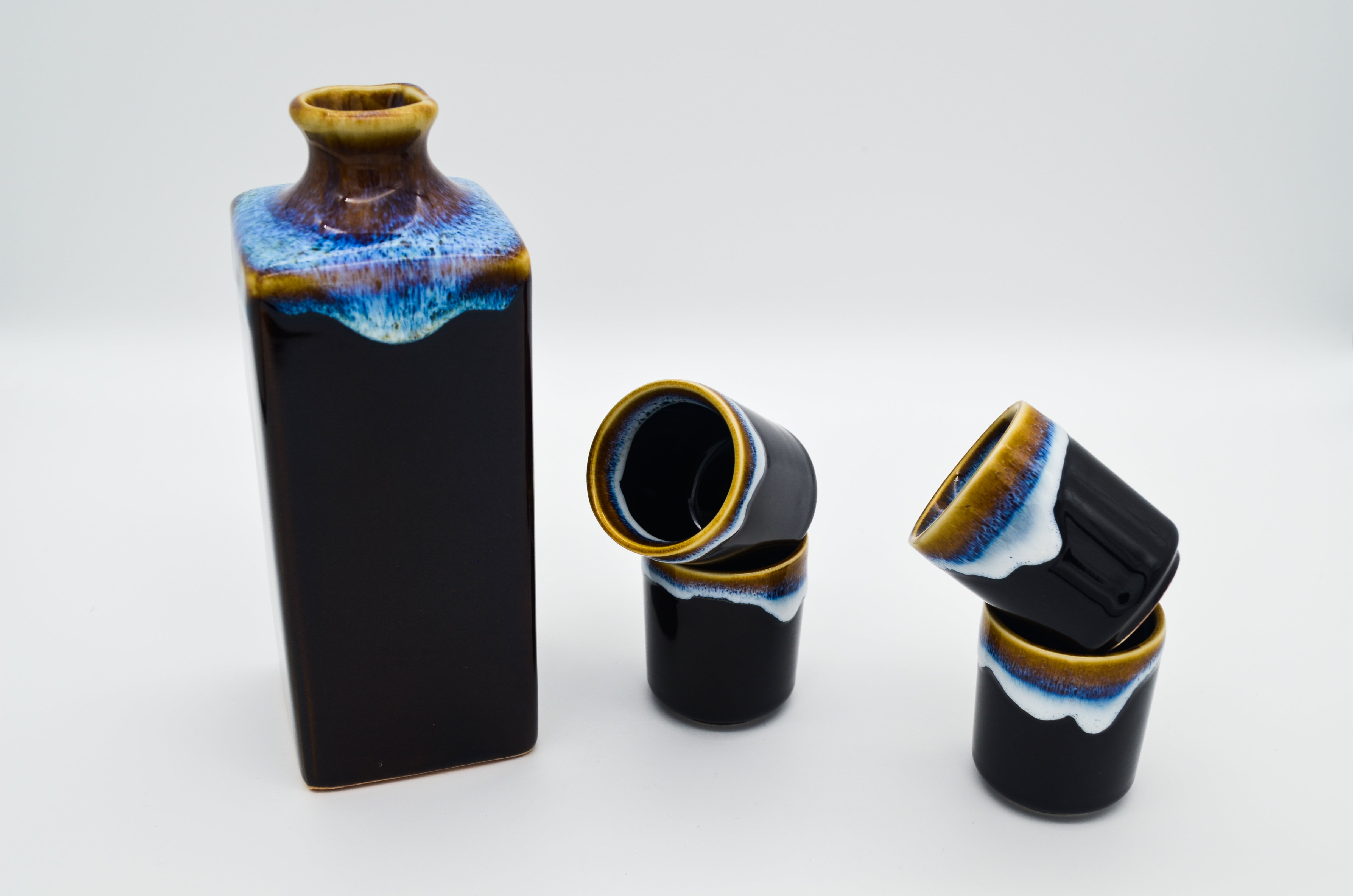 Three ceramic vases with unique designs on a white background