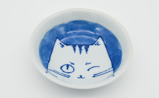Small white bowl with blue cat design on a white background