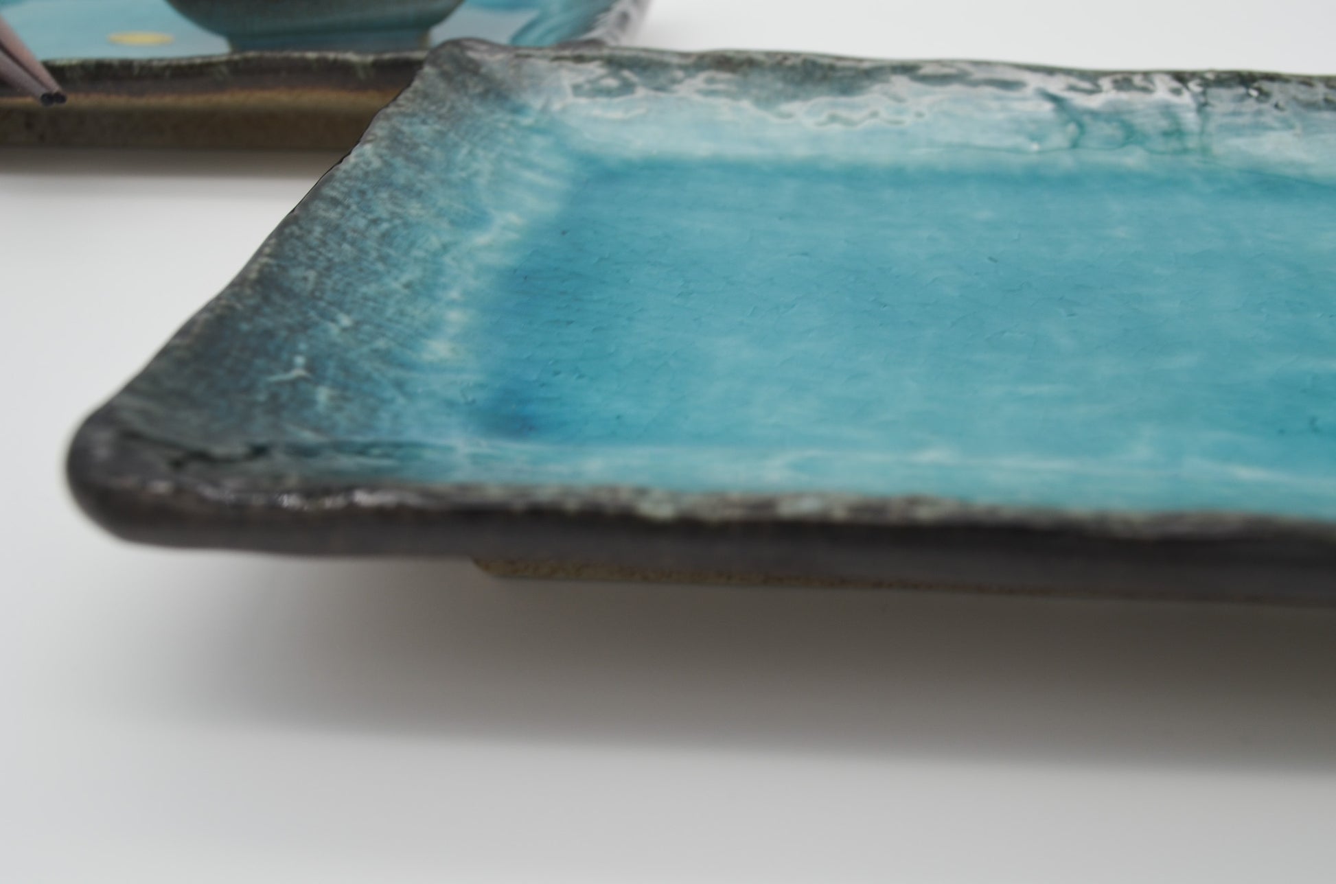 Blue ceramic plate with a textured edge on a white background