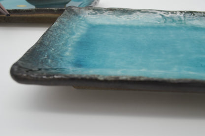 Blue ceramic plate with a textured edge on a white background
