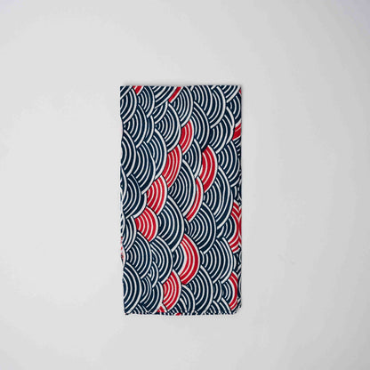 Fabric with red and blue wave pattern on a white background