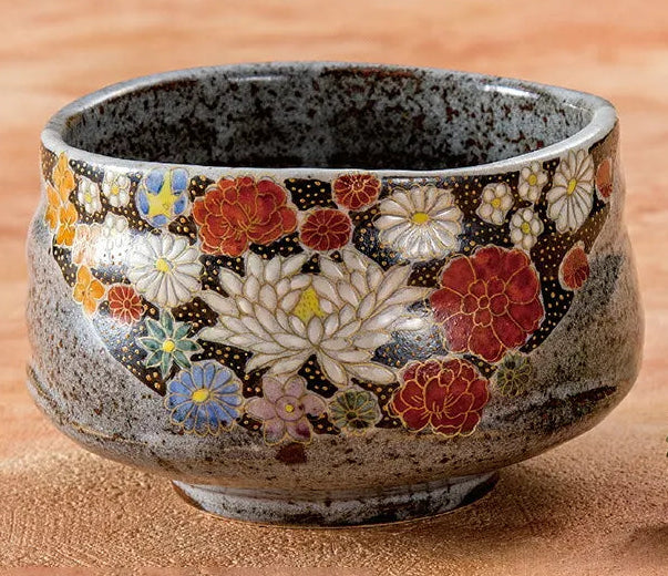 Ceramic bowl with floral patterns on a wooden surface