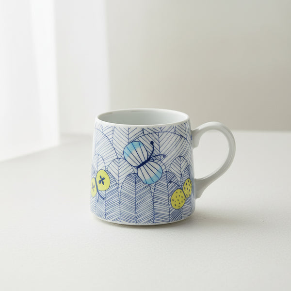 Ceramic mug with butterfly and lemon design on a white background