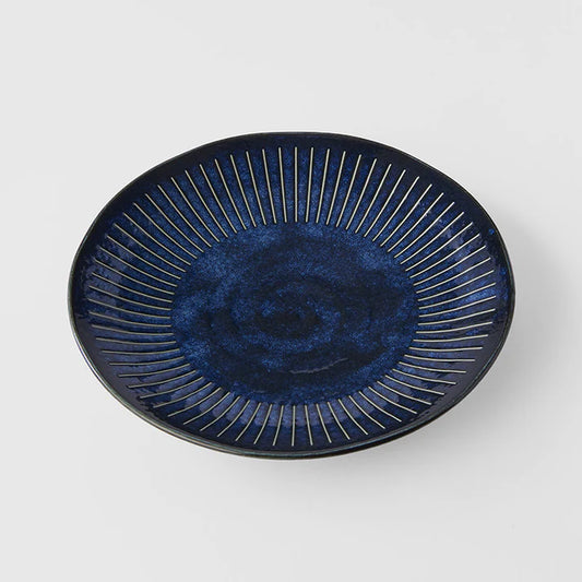 Blue ceramic plate with decorative design on a white background