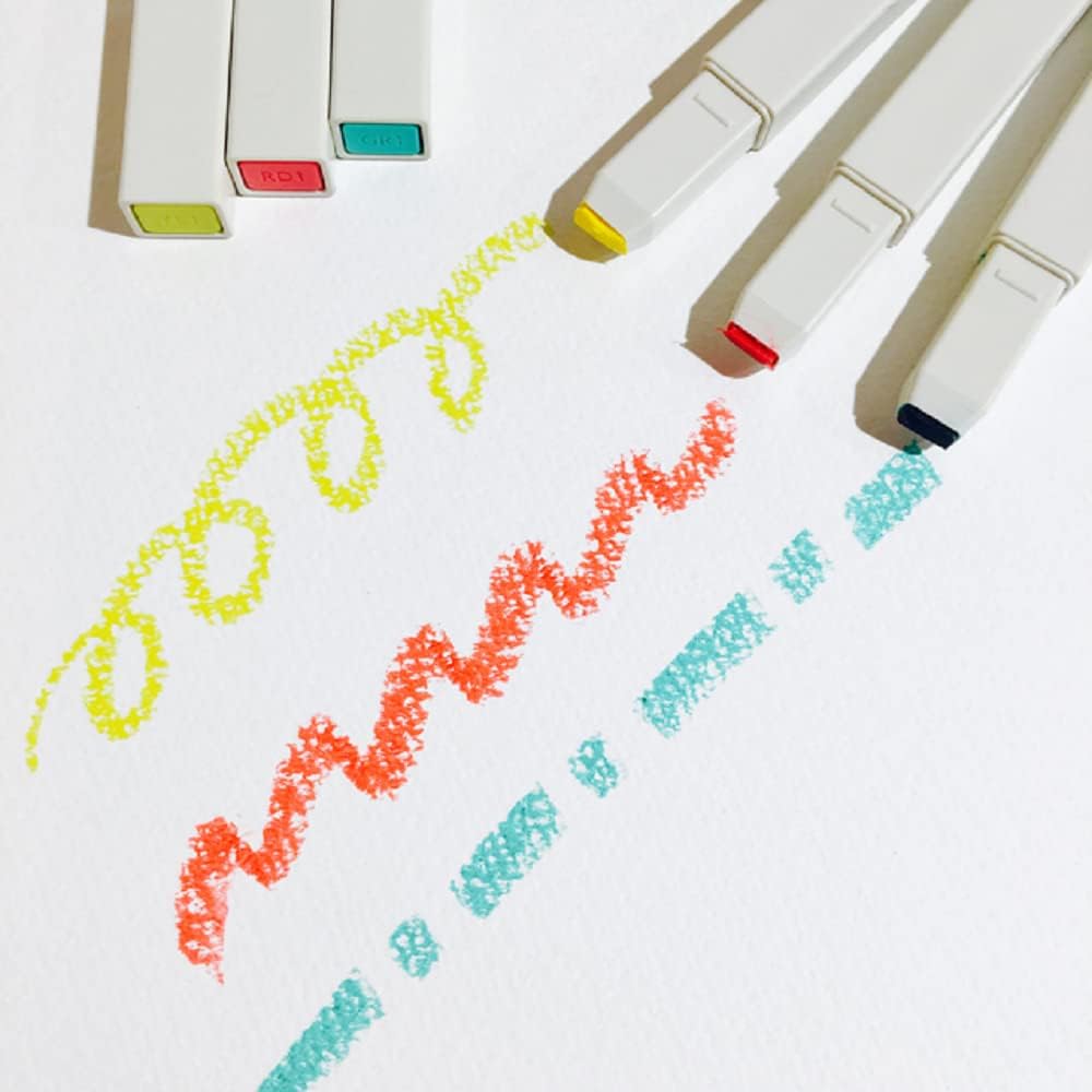 Colorful markers with colored caps on a white background