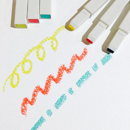 Colorful markers with colored caps on a white background