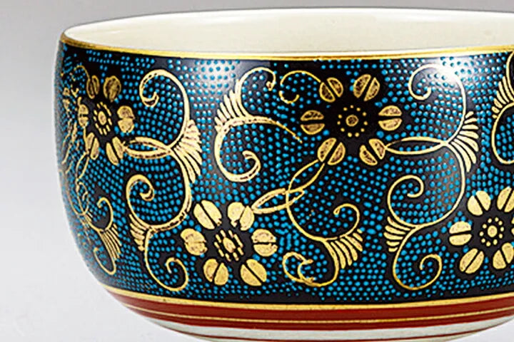 Decorative bowl with gold floral patterns on a blue background
