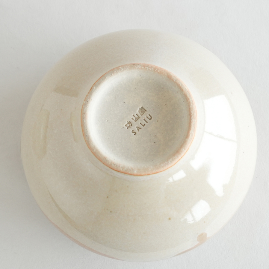 Ceramic bowl with visible branding on a white background