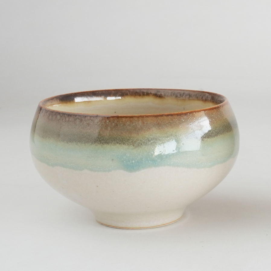 Ceramic bowl with a gradient glaze on a light gray background