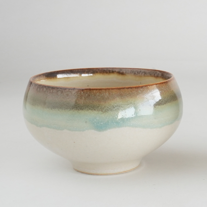 Ceramic bowl with a gradient glaze on a light gray background