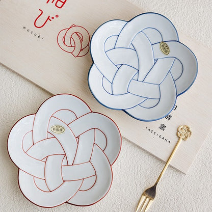 Two decorative plates with knot design on a light surface, featuring the brand 'Taseigama'. Japanese Ceramics. Made in Japan.