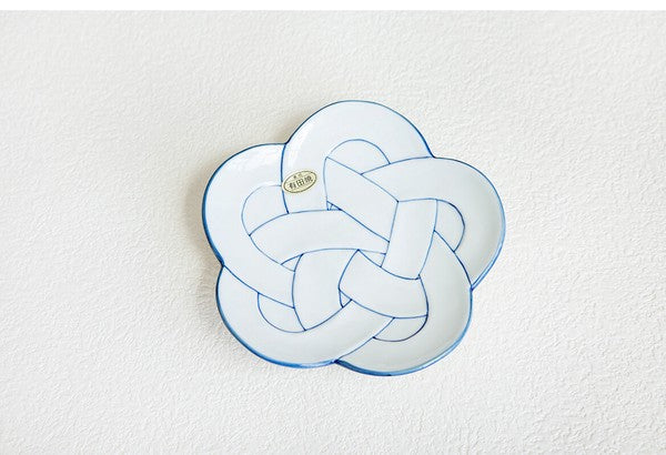 Decorative pillow with a plum knot design on a white background. Japanese Ceramics. Made in Japan.