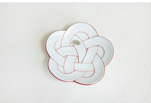 Decorative plate with a knot design on a textured white background. Japanese Ceramics. Made in Japan.