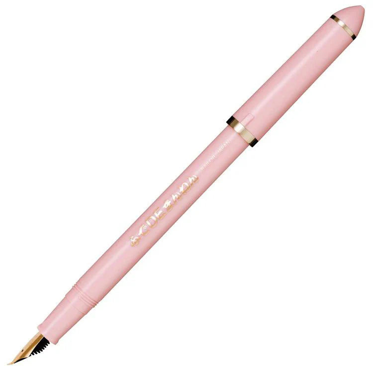 Pink pen with gold accents on a white background