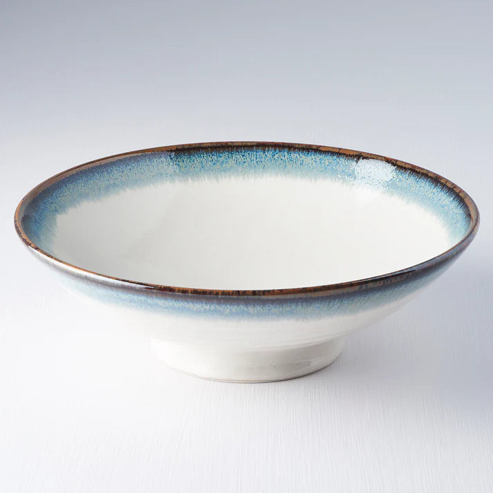 Ceramic bowl with blue rim on a white background