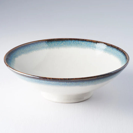 Ceramic bowl with blue rim on a white background