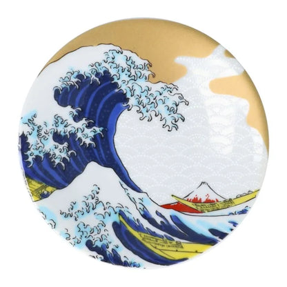 Round object with a design of a wave, boat, and mountain similar to 'The Great Wave' by Hokusai.