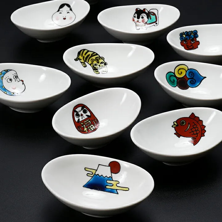 Set of small white bowls with colorful illustrations on a black background