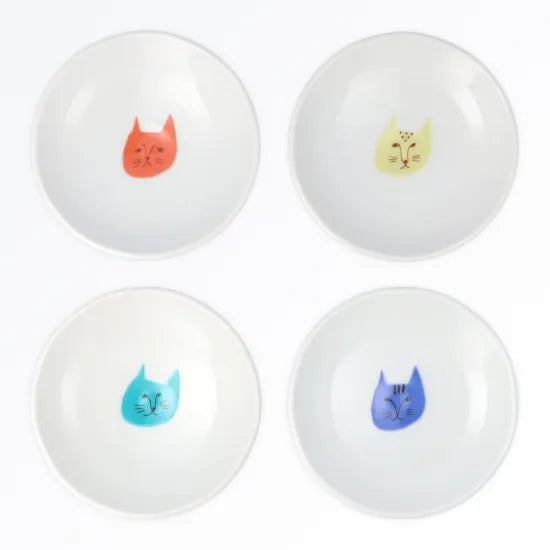 Four white balls with colorful cat illustrations on a white background