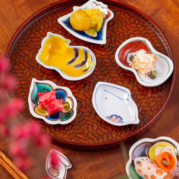 Assorted small dishes with food on a woven tray