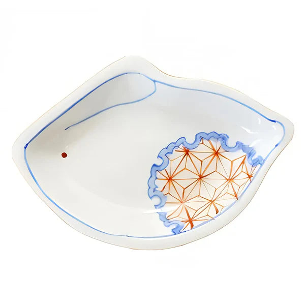 White ceramic dish with geometric orange design on a white background