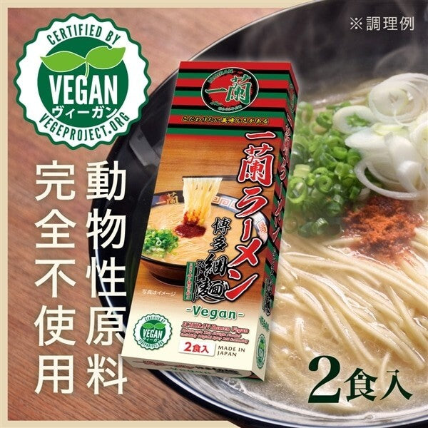 Vegan ramen package with a bowl of noodles and green onions on a wooden surface.