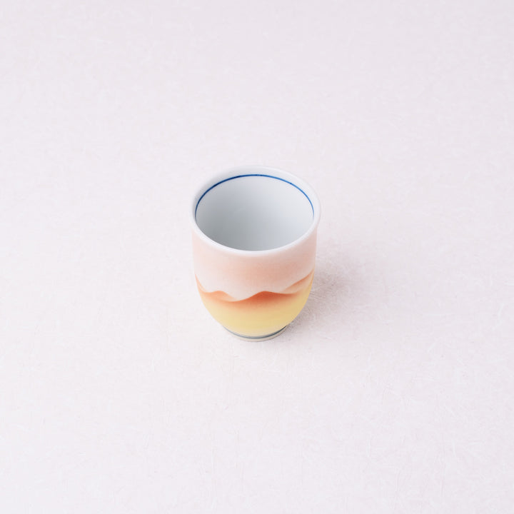 Ceramic mug with gradient design on a white background