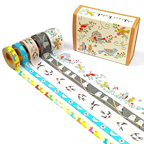 Set of washi tape rolls with decorative designs and a wooden box on a white background