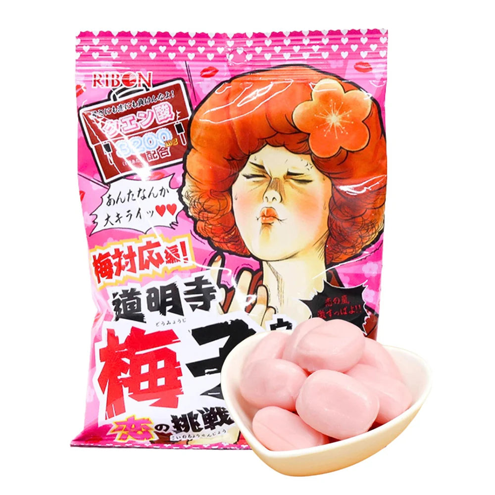 Pink candy package with cartoon character and bowl of candies on a white background